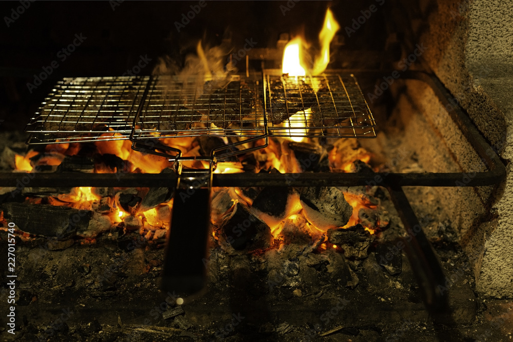 Grill with meat on a flaming charcoal grill with open fire at night. Concept of summer grilling, barbecue, bbq and party. Black copyspace. Grill with meat on a flaming charcoal grill with open fire at night. Concept of summer grilling, barbecue, bbq and party. Black copyspace.