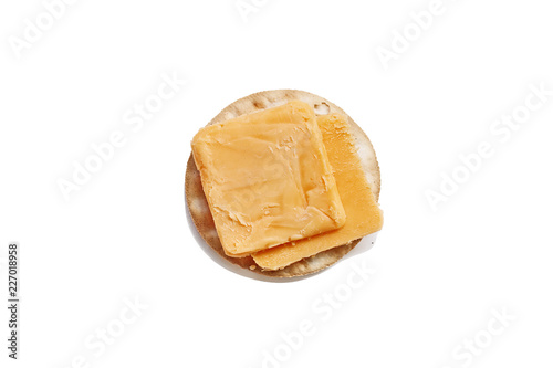 Isolated cheddar cheese slices and water cracker over a white background. Clipping path included.