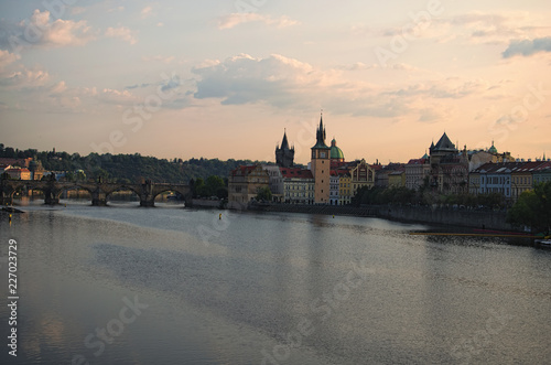 Picturesque view of the historical part of the city Prague during sunrise. Medieval Charles Bridge over Vltava River. Famous touristic place and travel destination in Europe. Prague, Czech Republic
