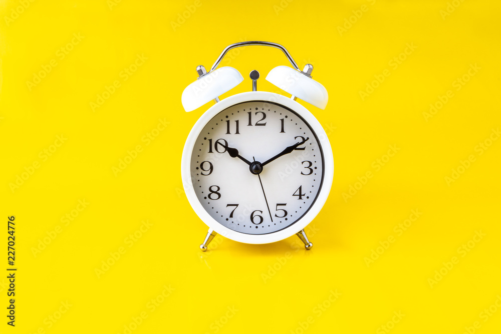 Clock on yellow background with selective focus and crop fragment. Copy space concept Clock on yellow background with selective focus and crop fragment. Copy space concept