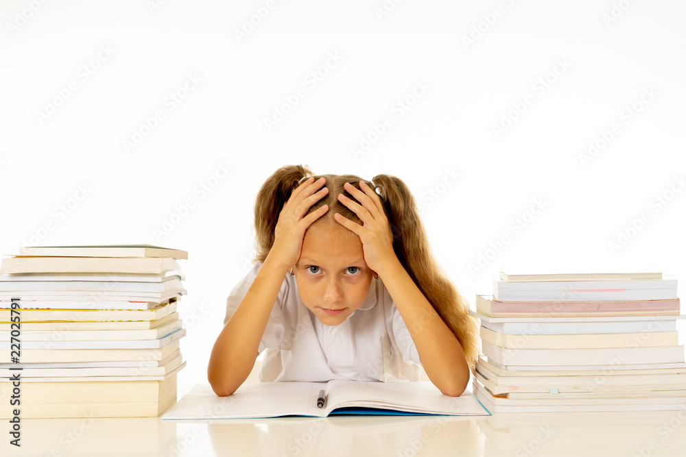 Sad unhappy cute little girl overwhelm with homework and studies Sad unhappy cute little girl overwhelm with homework and studies