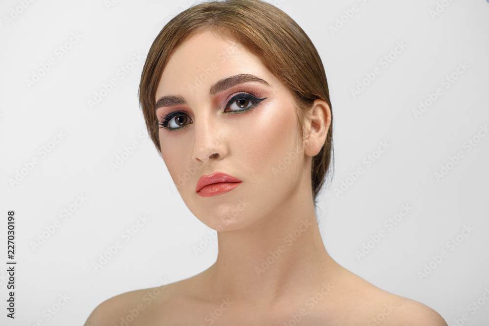Close up of young brown-eyed woman with perfect evening make up. Close up of young brown-eyed woman with perfect evening make up.