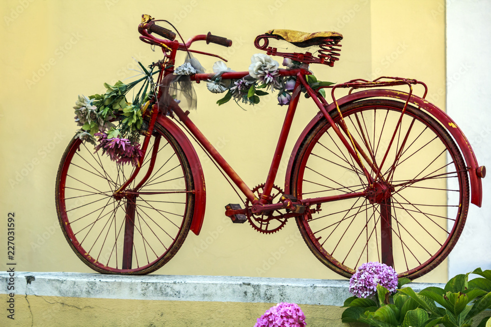 Red bicycle with flowers