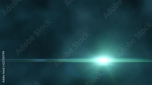 Bright light with lens flare moving. Blue background with spotlight beam. photo