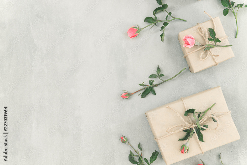 Pink rose flowers, gift box or present on gray stone table