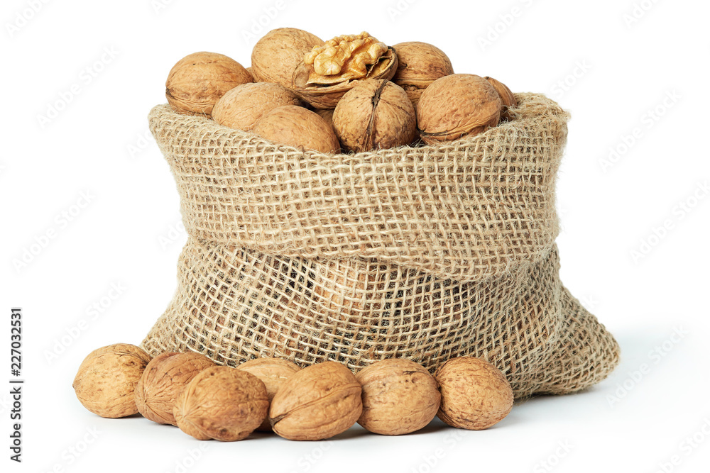 Whole walnuts (in shell) in burlap sack isolated on white background Whole walnuts (in shell) in burlap sack isolated on white background