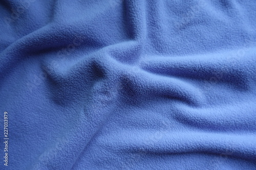 Thick blue fleece fabric in soft folds photo