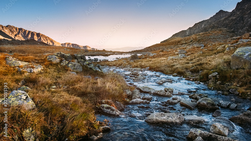 Flowing mountain river in High Tatras at sunset
