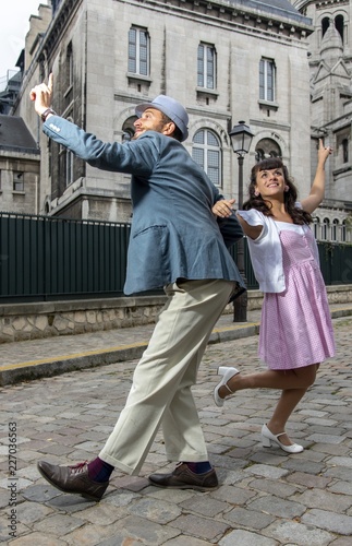 A couple of lovers dressed retro style dancing in the streets of Montmartre, Paris, France