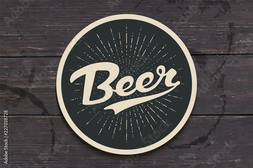 Coaster for beer with hand drawn lettering Beer. Monochrome vintage drawing for bar, pub and beer themes. Black circle for placing a beer mug or a bottle over it with lettering. Vector Illustration