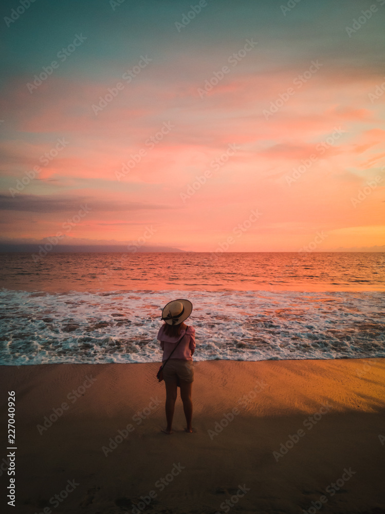 Woman watching beach sunset