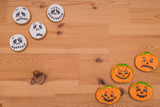 Funny Halloween Ghost Cookies. Emoticons pumpkins and ghosts on a wooden table