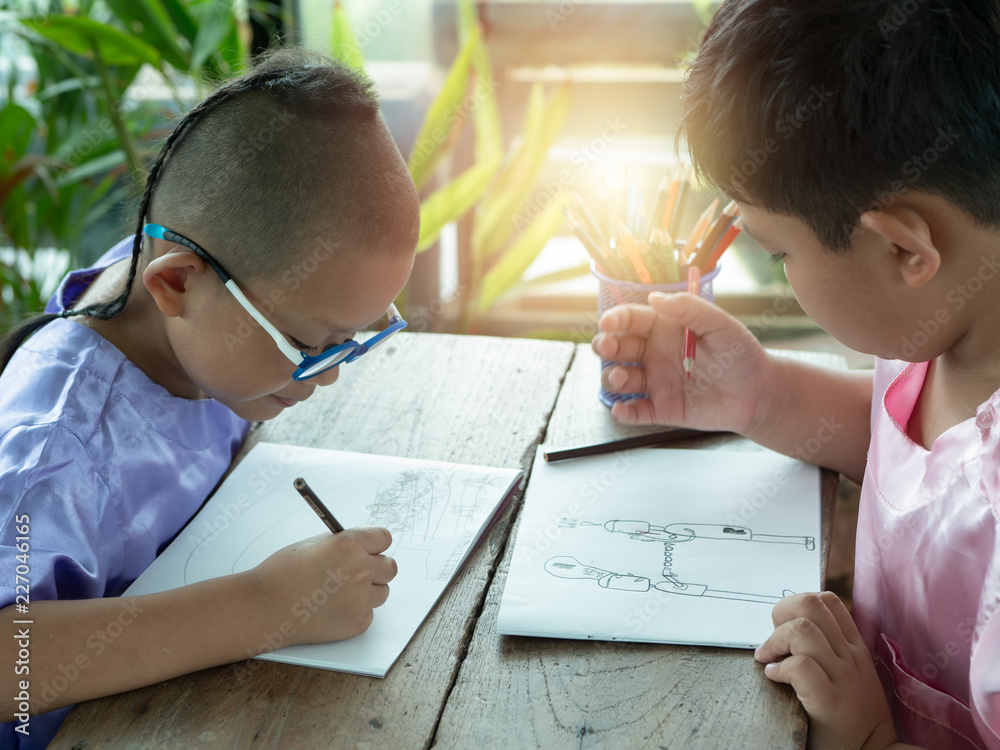Boy and friends intend drawing a picture fun, enjoy drawing or write in book at home. Boy and friends intend drawing a picture fun, enjoy drawing or write in book at home.
