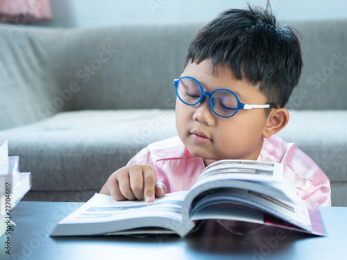 Boy reading a book at home. education concept