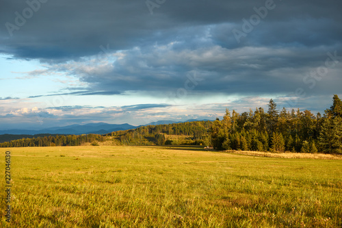 Czech landscape at sunset, Beskydy mountain in the distance, dark clouds on the sky