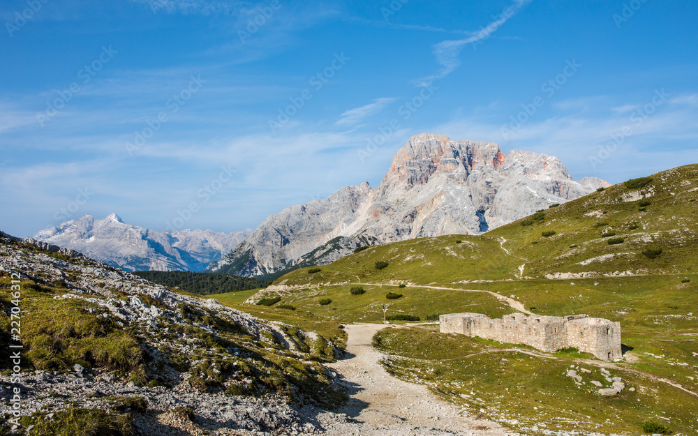 panorama with hiking trails and old ruin in foreground in south tyrol