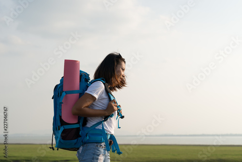 .Young travel asians woman with backpack walking in the road and sunlight. travel, adventure