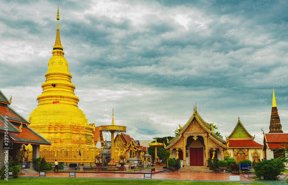 Fototapeta premium Golden Pagoda in Wat Phra That Hariphunchai temple in Lamphun province,Thailand.