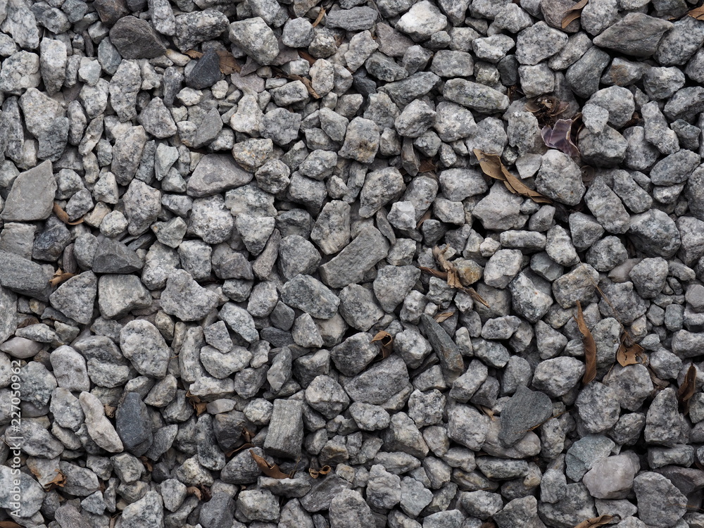 Crushed grey stone on the ground texture background Crushed grey stone on the ground texture background