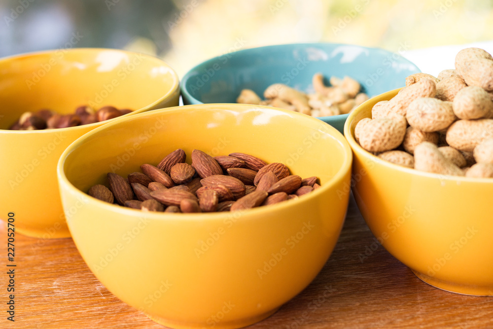 Assortment of mixed nuts on wood table background Assortment of mixed nuts on wood table background