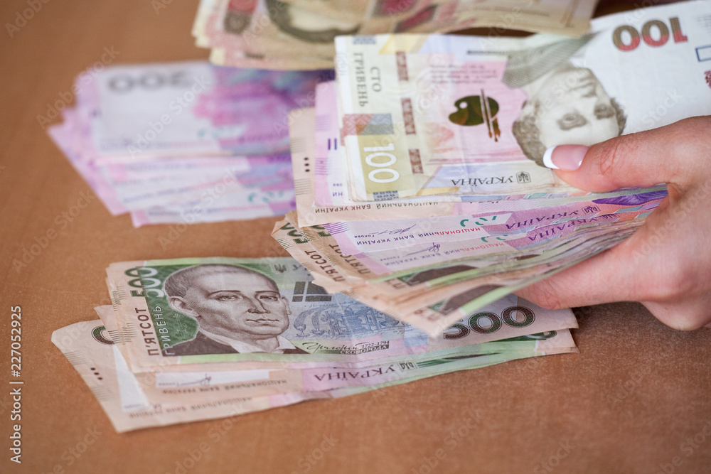 Hands holding Ukrainian money hryvnia. The national currency.