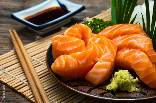 Sashimi, Salmon, Japanese food chopsticks and wasabi on the table