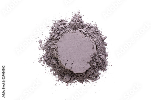 Pile of yellow  black cosmetic clay isolated on white background