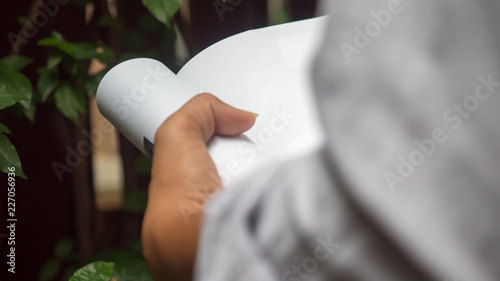 Man reading Book in his hands at garden
