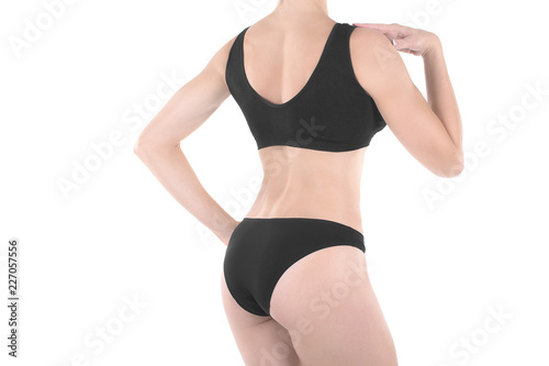 Female cropped fit back and buttocks in black panties and top, isolated on white.