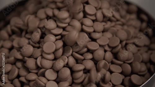 Pouring chocolate into bowl for tempering. Technology of production of sweets in factory