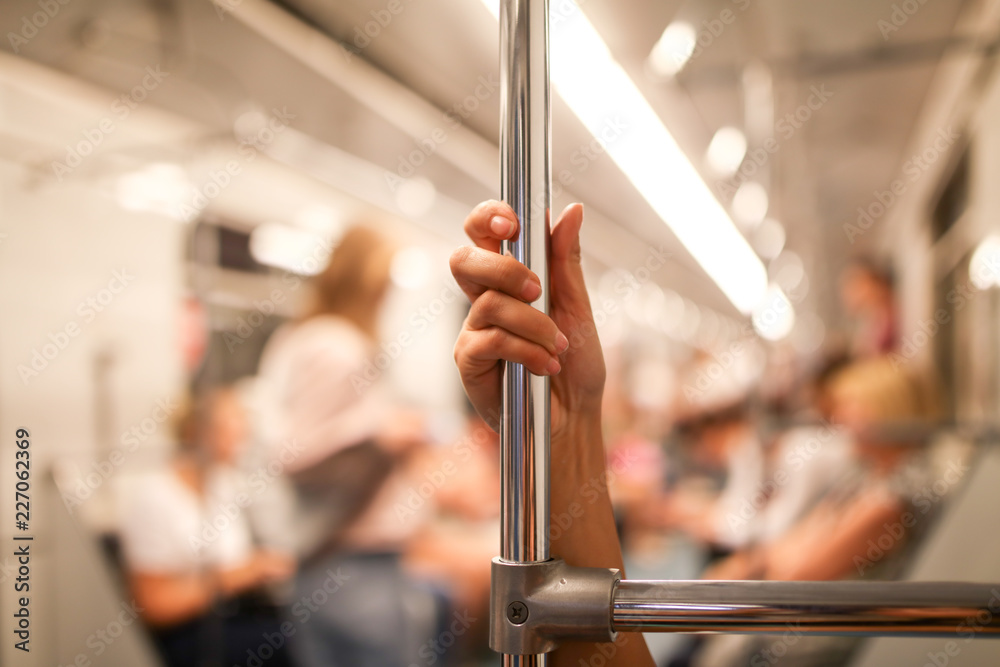 The girl's hand holds the handle in the metro The girl's hand holds the handle in the metro