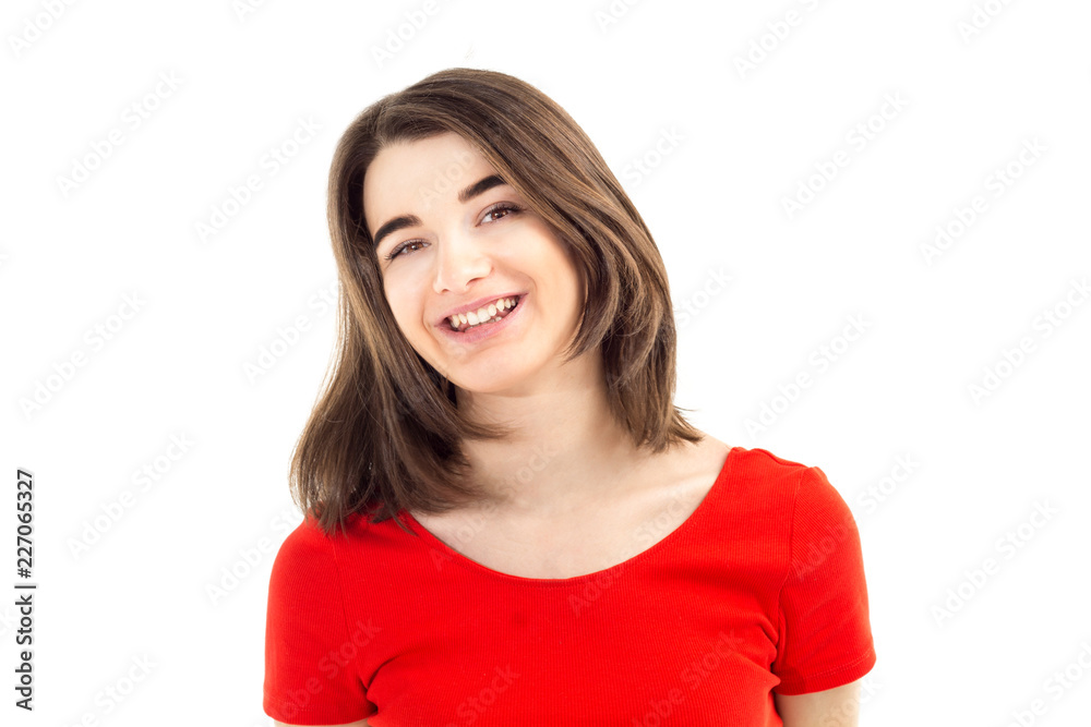 Closeup portrait of a young happy smiling girl in red t-shirt against white background, lifestyle and people concept Closeup portrait of a young happy smiling girl in red t-shirt against white background, lifestyle and people concept