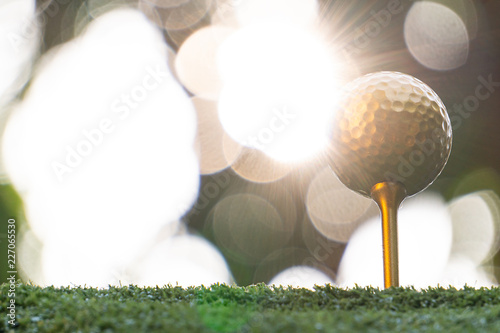 Konstfotografi Gold golf ball and pins with a bright light, the ultimate victory of golf