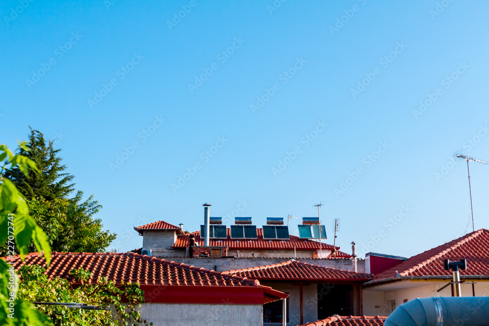 Solar panel, water heater on house roof, green energy Solar panel, water heater on house roof, green energy