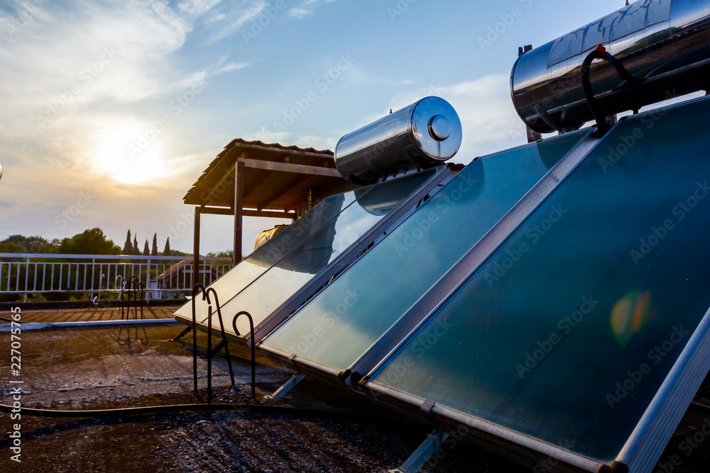 Solar panel, water heater on house roof, green energy Solar panel, water heater on house roof, green energy