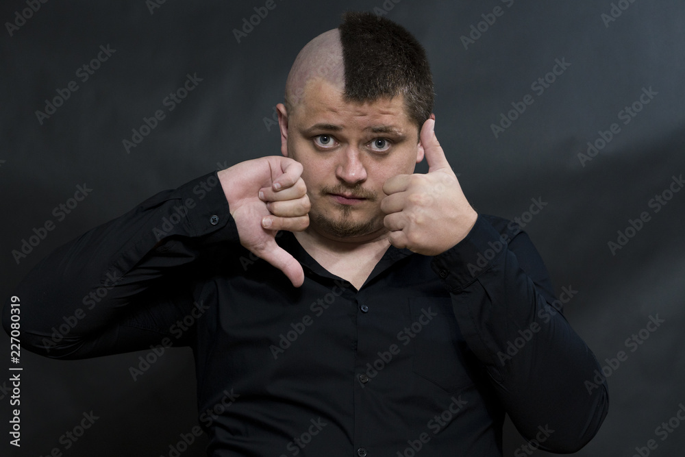 Punk. The finger of one hand points down. The other hand points up. Contradiction gestures. Punk. The finger of one hand points down. The other hand points up. Contradiction gestures.