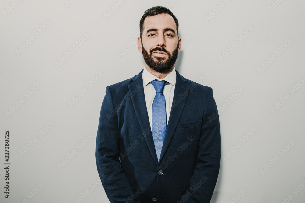 Young businessman, dressed in suit and tie placed on a neutral background. Different facial gestures, expressing emotions. Lifestyle. Young businessman, dressed in suit and tie placed on a neutral background. Different facial gestures, expressing emotions. Lifestyle.