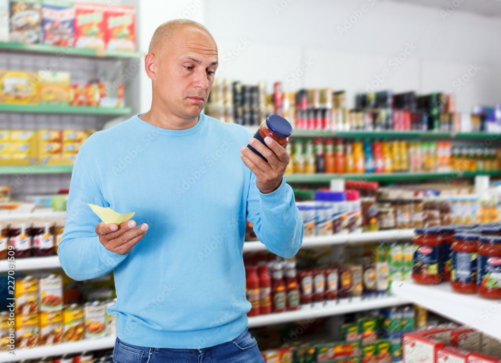 Portrait of attentive man making purchases in the grocery store