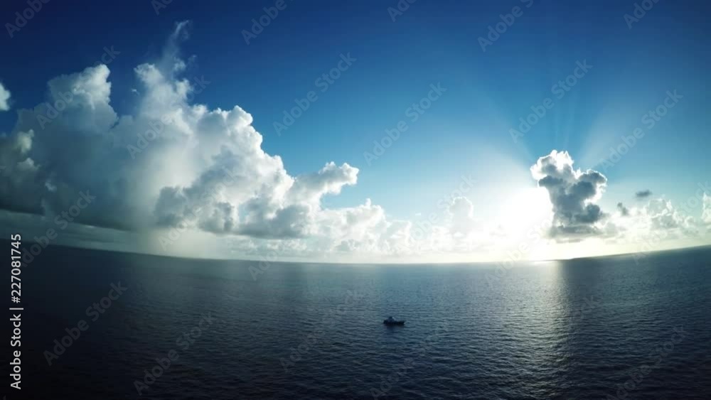 Wide aerial, heavenly light over ocean