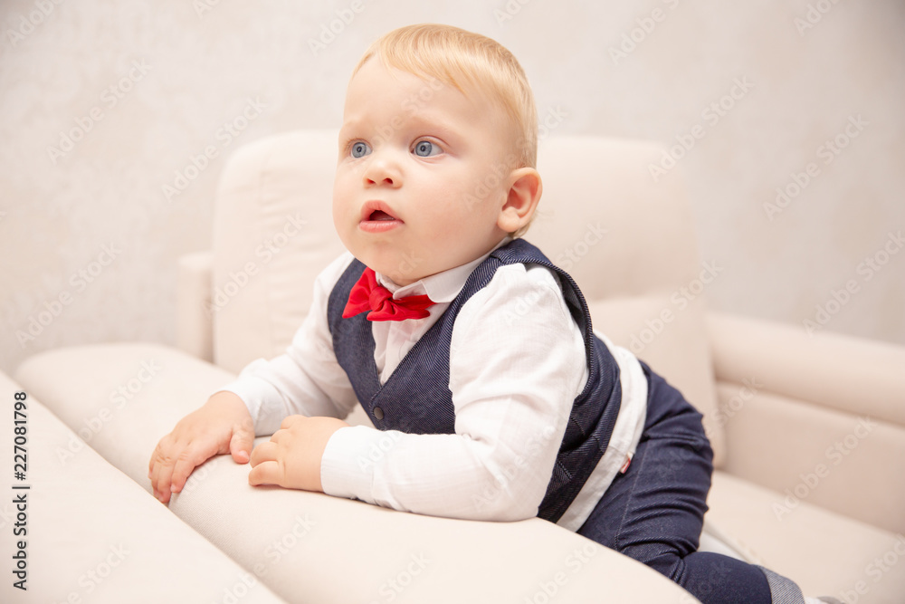 Happy baby. Little boy in a white shirt and bow tie. Children portrait. Stylish man in fashionable a bow-tie. Happy baby. Little boy in a white shirt and bow tie. Children portrait. Stylish man in fashionable a bow-tie.