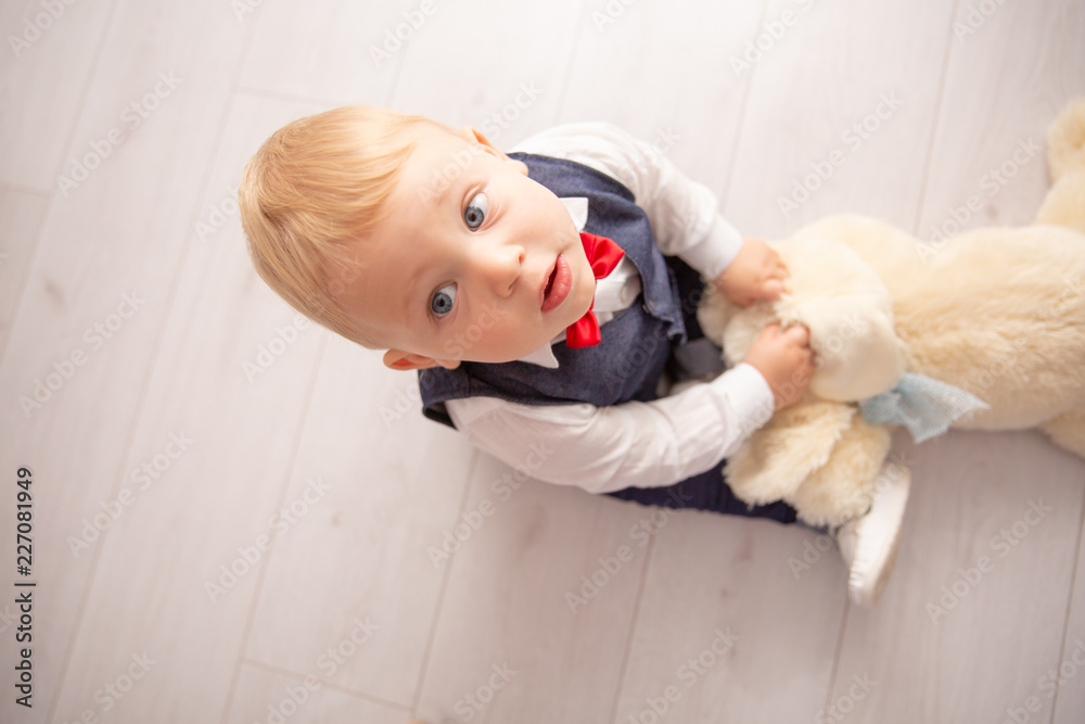 Happy baby. Little boy in a white shirt and bow tie. Children portrait. Stylish man in fashionable a bow-tie. Happy baby. Little boy in a white shirt and bow tie. Children portrait. Stylish man in fashionable a bow-tie.