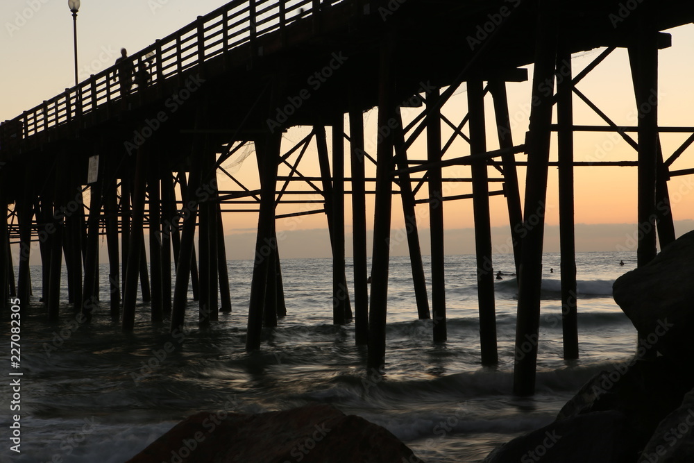 Sunset peeping under ocean pier