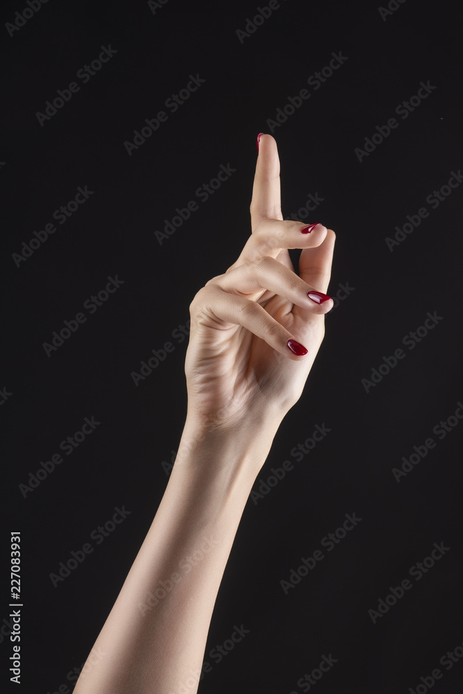Closeup of beautiful woman hand with red manicure on the nails. Cream for palms, manicure and beauty treatment. Elegant and graceful arm with slender graceful fingers Closeup of beautiful woman hand with red manicure on the nails. Cream for palms, manicure and beauty treatment. Elegant and graceful arm with slender graceful fingers