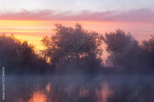 Sunrise over the pond. Foggy morning at the pond.