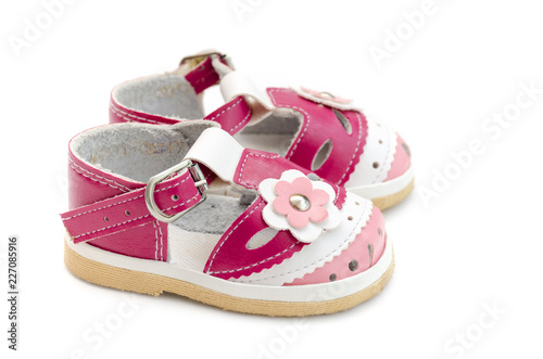 Pink baby shoes isolated on white background.