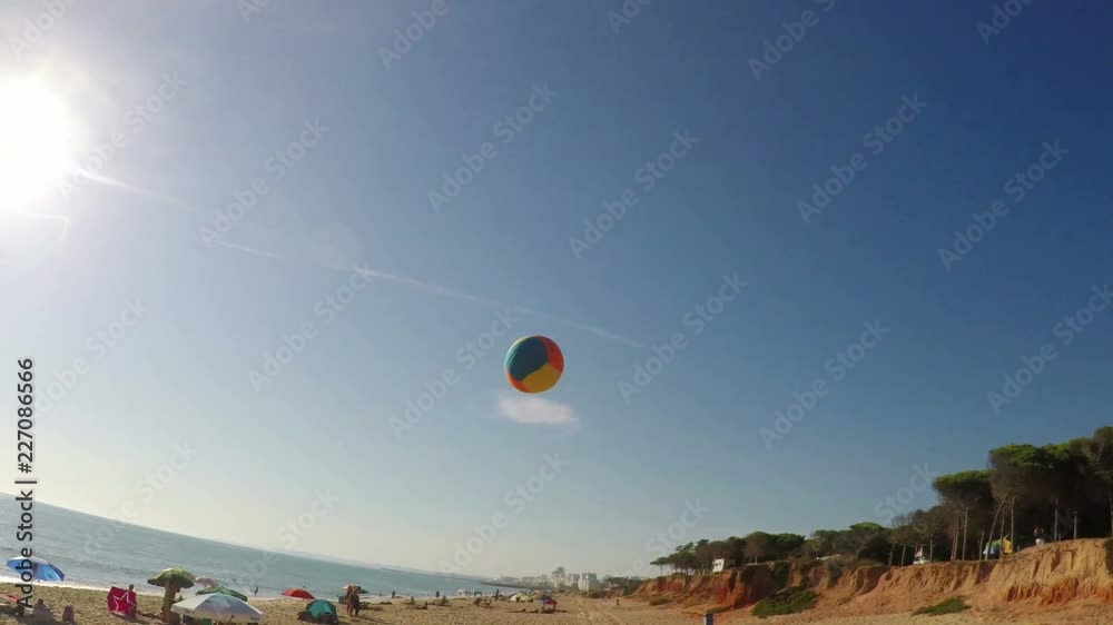 Father plays beach volleyball with his daughter. Shooting from the first person.