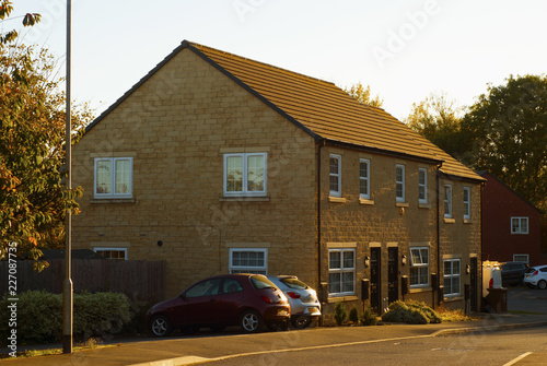 Typical English brick house. Autumn sunny day. Street view.