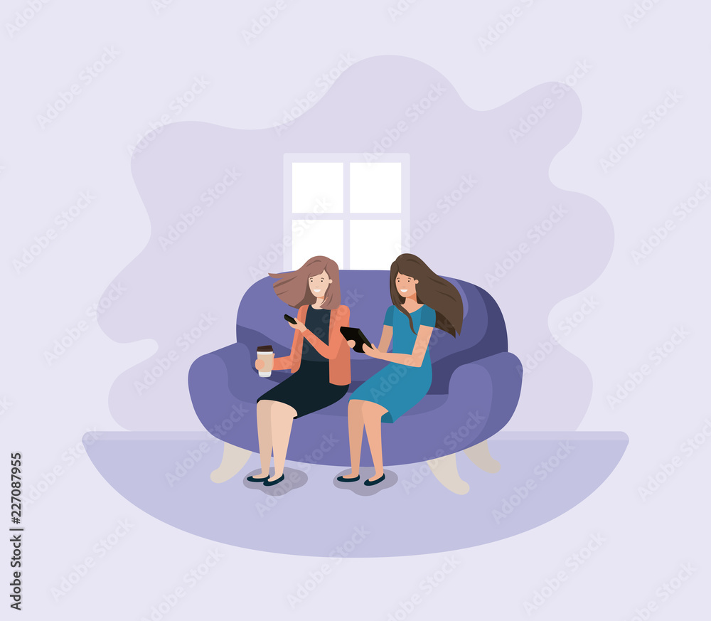 couple of women in living room using technology