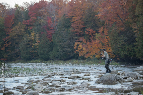 Man fly fishing in the fall in a river
