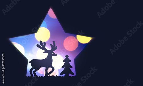 christmas closeup of reindeer near a pine tree on a colorful violet bokeh background